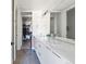 Bright bathroom featuring a dual vanity with modern fixtures and a walk-in closet at 5125 W 29Th Ave # 5, Denver, CO 80212