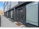 Modern townhome showcases a sleek, dark exterior, and a minimalist front entrance with large windows and secure entry at 5125 W 29Th Ave # 5, Denver, CO 80212