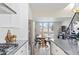 Bright, open kitchen with modern appliances flowing into the dining area and naturally lit living space at 5125 W 29Th Ave # 5, Denver, CO 80212