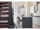 A modern kitchen featuring an island with bar stools, sleek countertops, and stainless steel appliances at 5125 W 29Th Ave # 5, Denver, CO 80212