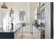 Bright kitchen featuring an island with seating, modern appliances, and white cabinets at 5125 W 29Th Ave # 5, Denver, CO 80212