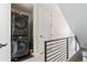 Convenient upstairs laundry closet with a stacked washer and dryer set at 5125 W 29Th Ave # 5, Denver, CO 80212