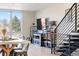 Bright living room with adjacent dining area featuring a staircase and open floor plan at 5125 W 29Th Ave # 5, Denver, CO 80212