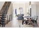 Bright living room with modern floating stairs, open concept to kitchen, and dining area, boasting light hardwood floors at 5125 W 29Th Ave # 5, Denver, CO 80212