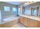 Serene bathroom featuring a soaking tub, double sink vanity, and recessed lighting at 10550 Ashfield St, Highlands Ranch, CO 80126