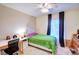 Cozy bedroom with bright window, desk and ceiling fan at 10550 Ashfield St, Highlands Ranch, CO 80126