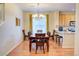 Inviting dining room featuring a wooden table, chandelier, and natural light at 10550 Ashfield St, Highlands Ranch, CO 80126
