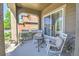 Cozy front porch with comfortable seating and shaded area, creating a relaxing outdoor space at 10550 Ashfield St, Highlands Ranch, CO 80126