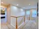 Upstairs hallway with white trim and ample natural light from two bright windows at 10550 Ashfield St, Highlands Ranch, CO 80126