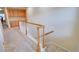 Upstairs hallway with carpet, wood railing and natural light at 10550 Ashfield St, Highlands Ranch, CO 80126