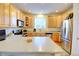 Bright kitchen with stainless steel appliances, countertops, and ample cabinet space at 10550 Ashfield St, Highlands Ranch, CO 80126