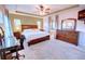 Spacious main bedroom showcasing a large bed, a ceiling fan, and a large window at 10550 Ashfield St, Highlands Ranch, CO 80126
