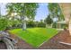 Nicely landscaped backyard with mature trees and fresh green grass at 2391 S Quitman St, Denver, CO 80219