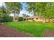 Expansive backyard with well-maintained lawn, mature trees, patio and manicured mulch beds at 2391 S Quitman St, Denver, CO 80219