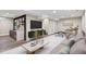 Finished basement area with a wet bar, entertainment center, and cozy seating at 2391 S Quitman St, Denver, CO 80219