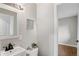 Bathroom with modern sink, stylish mirror, and decorative flower wall art at 2391 S Quitman St, Denver, CO 80219