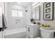 Bright bathroom features white subway tile, modern fixtures, and decorative accents at 2391 S Quitman St, Denver, CO 80219
