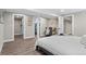 Spacious bedroom featuring wood flooring, closet, and an ensuite bathroom at 2391 S Quitman St, Denver, CO 80219
