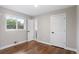 Bright bedroom features hardwood floors, white trim and doors, and a large window at 2391 S Quitman St, Denver, CO 80219