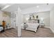 Neutral bedroom boasts wood flooring and white trim at 2391 S Quitman St, Denver, CO 80219