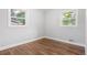A bedroom with hardwood floors and dual windows lets in ample natural light at 2391 S Quitman St, Denver, CO 80219