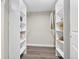 Organized walk-in closet with custom shelving and wood flooring at 2391 S Quitman St, Denver, CO 80219