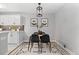 Cozy dining area with modern light fixture, stylish rug, and seating for four at 2391 S Quitman St, Denver, CO 80219