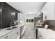 Sleek kitchen featuring modern appliances, countertops, and an elegant dark backsplash at 2391 S Quitman St, Denver, CO 80219