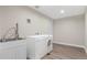 Functional laundry room featuring modern appliances, a sink, and ample counter space at 2391 S Quitman St, Denver, CO 80219