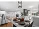 Stylishly designed open-concept living space features hardwood floors, modern decor, and a dining area at 2391 S Quitman St, Denver, CO 80219