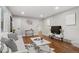 Cozy living room featuring hardwood floors, contemporary decor, and ample natural light at 2391 S Quitman St, Denver, CO 80219