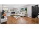 Bright living room featuring hardwood floors, a large window, and modern furnishings at 2391 S Quitman St, Denver, CO 80219