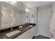 Modern bathroom featuring double sinks, stylish fixtures, and a shower with sleek, white tiling at 1534 Irving St, Denver, CO 80204