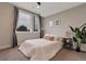 Bright bedroom with a large window, plush white comforter, decorative pillows and artwork on the wall at 1534 Irving St, Denver, CO 80204
