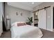 Bright bedroom featuring a sliding barn door to the bathroom and neutral decor, creating a serene retreat at 1534 Irving St, Denver, CO 80204