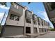 Modern townhome exterior featuring gray trim, white walls, and multiple garage entrances at 1534 Irving St, Denver, CO 80204