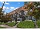 Modern townhome with balconies, contrasting wood and dark siding, and landscaped front entrances under a blue sky at 1534 Irving St, Denver, CO 80204