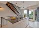 Kitchen island with barstool seating, stainless steel sink, and modern lighting fixtures at 1534 Irving St, Denver, CO 80204