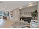 Bright, open-concept living area with modern furniture, adjacent kitchen, and hardwood floors at 1534 Irving St, Denver, CO 80204