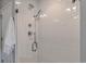 Close-up of modern tiled shower with a sleek, chrome shower head and glass door for a spa-like experience at 1534 Irving St, Denver, CO 80204