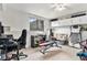 Versatile basement area equipped with exercise equipment, a desk, and ample storage space for various activities at 3852 S Genoa Ct # B, Aurora, CO 80013