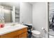 Clean bathroom featuring a vanity with a sink, a toilet, and a shower with shelving for toiletries at 3852 S Genoa Ct # B, Aurora, CO 80013