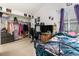 Comfortable bedroom with a spacious closet, a desk, and a large window providing natural light at 3852 S Genoa Ct # B, Aurora, CO 80013