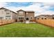 Well-maintained back yard featuring green lawn and a wood fence at 870 Mosquito Ct, Elizabeth, CO 80107