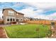 Spacious backyard features a well-maintained lawn, wood fence, and outdoor patio at 870 Mosquito Ct, Elizabeth, CO 80107