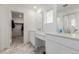 Bright bathroom featuring double vanity, marble floors, and a walk-in closet at 870 Mosquito Ct, Elizabeth, CO 80107