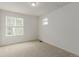 A carpeted bedroom with natural light filtering through the windows at 870 Mosquito Ct, Elizabeth, CO 80107