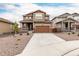 Two-story home with brown siding, a concrete driveway and a two-car garage at 870 Mosquito Ct, Elizabeth, CO 80107