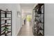 Bright hallway with wood floors and decor shelves leading to open kitchen and dining area at 870 Mosquito Ct, Elizabeth, CO 80107