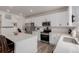 Modern kitchen with white cabinets, stainless steel appliances, and quartz countertops at 870 Mosquito Ct, Elizabeth, CO 80107